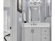 Elegant bathroom vanity with white cabinets, updated fixtures, and a framed mirror at 4791 Arco Ln, North Charleston, SC 29418