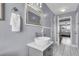 Bright bathroom featuring a vessel sink, modern faucet, and open doorway to the bedroom at 4791 Arco Ln, North Charleston, SC 29418