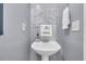 Charming bathroom featuring a pedestal sink with a framed print hanging above at 4791 Arco Ln, North Charleston, SC 29418