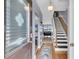Bright foyer featuring hardwood floors, staircase and views into the living spaces at 4791 Arco Ln, North Charleston, SC 29418