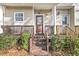 Inviting front porch with wood railings and lush greenery welcomes you home at 4791 Arco Ln, North Charleston, SC 29418