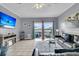 Open living room with tile flooring, ceiling fan, and water view through sliding glass doors at 4791 Arco Ln, North Charleston, SC 29418