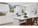 Bright kitchen with white cabinets, quartz countertops, stainless steel appliances, and stylish breakfast bar at 5023 Scow Ct, Summerville, SC 29485