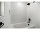 A well-lit bathroom with white subway tiles and a modern black shower head and fixtures at 519 Bank St, Mount Pleasant, SC 29464