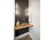 Modern powder room featuring a vessel sink, wood counter, and stylish vertical tile at 519 Bank St, Mount Pleasant, SC 29464