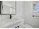 Modern bathroom featuring a sleek vanity with black fixtures, a large mirror, and subway tile walls at 519 Bank St, Mount Pleasant, SC 29464