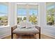 Sun-drenched bedroom alcove with built in bench seat overlooking neighborhood at 519 Bank St, Mount Pleasant, SC 29464