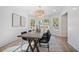 Elegant dining room with shiplap walls, modern light fixture, and bay windows at 519 Bank St, Mount Pleasant, SC 29464