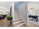 Inviting entryway with stairs leading to the upper level and an open view into the dining area at 519 Bank St, Mount Pleasant, SC 29464