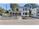 Two-story house features eye-catching curb appeal, large windows and nice landscaping at 519 Bank St, Mount Pleasant, SC 29464