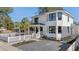 Beautiful two-story home boasts manicured landscaping, decorative fence, and charming front porch at 519 Bank St, Mount Pleasant, SC 29464