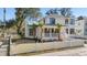 Beautiful home with a white picket fence, lush green lawn, mature trees, and a welcoming front porch at 519 Bank St, Mount Pleasant, SC 29464