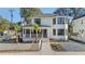Charming two-story home boasts a white picket fence, manicured landscaping, and a welcoming front porch at 519 Bank St, Mount Pleasant, SC 29464