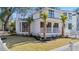 Charming home with a well-maintained lawn, mature trees, and an inviting screened-in porch at 519 Bank St, Mount Pleasant, SC 29464