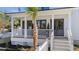 Charming front porch with white railing, gray doors, and a manicured front yard at 519 Bank St, Mount Pleasant, SC 29464