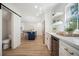 Open-concept kitchen featuring a blue island, white cabinets, and wood-style flooring at 519 Bank St, Mount Pleasant, SC 29464