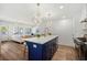 Open concept kitchen with a central island, stainless appliances, and seamless transition to the living area at 519 Bank St, Mount Pleasant, SC 29464