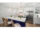 Stylish kitchen with blue island, quartz countertop, stainless steel appliances, and modern lighting at 519 Bank St, Mount Pleasant, SC 29464