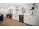 Beautiful white kitchen with stainless steel appliances, beverage fridge, and floating shelves at 519 Bank St, Mount Pleasant, SC 29464