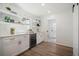 Bright kitchen featuring a beverage cooler, floating shelves, and a view to the outdoors at 519 Bank St, Mount Pleasant, SC 29464