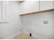 Bright laundry room with white cabinets, herringbone tile floors, and white trim at 519 Bank St, Mount Pleasant, SC 29464