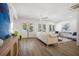 Bright living room featuring hardwood floors, shiplap walls, and elegant French doors leading to the outdoors at 519 Bank St, Mount Pleasant, SC 29464