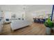 Open-concept living room features modern decor, hardwood floors, and a view of the kitchen island with barstool seating at 519 Bank St, Mount Pleasant, SC 29464