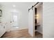 Stylish powder room with sliding barn door, unique lighting, and modern vanity at 519 Bank St, Mount Pleasant, SC 29464