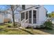 Inviting screened porch featuring white railings and an outdoor ceiling fan at 519 Bank St, Mount Pleasant, SC 29464