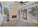 Relaxing screened porch with a brick fireplace, comfortable seating, and a view of the surrounding landscape at 519 Bank St, Mount Pleasant, SC 29464