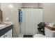 Bright bathroom showcases a toilet, vanity, and a shower with a white curtain at 5334 Charleston Highway Hwy, Walterboro, SC 29488