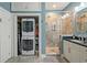 Bathroom features stackable washer/dryer and granite counter vanity with glass enclosed shower at 54 Warren St, Charleston, SC 29403