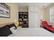 Cozy bedroom featuring a bookshelf, white closet doors, and a comfortable red chair at 54 Warren St, Charleston, SC 29403