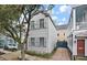 Charming two-story home featuring light gray exterior, shutters, and a well-maintained lawn at 54 Warren St, Charleston, SC 29403