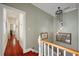 Upstairs hallway with decorative lighting, wood floors and stylish decorations at 54 Warren St, Charleston, SC 29403