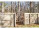 Wooden fence and gate to a lush, green backyard with mature trees in the background at 544 Beverly Dr, Summerville, SC 29485