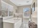 Bright bathroom featuring a large soaking tub, windows, and neutral tones at 544 Beverly Dr, Summerville, SC 29485