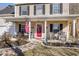Inviting front porch with red door, American flag, seating and decorative plants at 544 Beverly Dr, Summerville, SC 29485