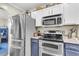 Well-equipped kitchen with stainless steel refrigerator, stove, microwave and ample counter space at 544 Beverly Dr, Summerville, SC 29485