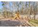 Wooden playground with a slide and swings set amongst mature trees with wooden fence surrounding at 544 Beverly Dr, Summerville, SC 29485