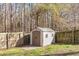 Outdoor storage shed with double doors in a fenced backyard with mature trees at 544 Beverly Dr, Summerville, SC 29485