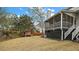 Backyard with a wooden fence, large grass area, and a screened-in porch attached to the home at 59 Oyster Point, Charleston, SC 29412