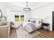 Calming main bedroom with natural light, light-colored walls and hardwood floors at 640 Cottage Landing Drive, Summerville, SC 29485