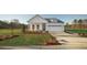 Inviting single-story home with a pristine lawn, covered porch, and a convenient two-car garage at 640 Cottage Landing Drive, Summerville, SC 29485