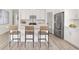 Clean kitchen with white cabinets, subway tile backsplash, stainless steel appliances, and a center island with bar stool seating at 640 Cottage Landing Drive, Summerville, SC 29485