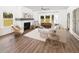 Bright and airy living room boasts a white brick fireplace, plush seating, and ample natural light through large windows at 640 Cottage Landing Drive, Summerville, SC 29485