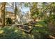 Beautiful backyard with garden plots, lush landscaping, and a charming wooden building with a metal roof at 65 Surfsong Rd, Kiawah Island, SC 29455