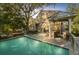 Backyard oasis with a sparkling pool, outdoor kitchen, dining area, and cozy seating for entertaining at 65 Surfsong Rd, Kiawah Island, SC 29455