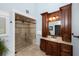 This bathroom features a beautiful tiled shower with a glass door and a marble-topped wood vanity at 65 Surfsong Rd, Kiawah Island, SC 29455