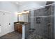 Bathroom featuring a glass enclosed shower, granite vanity and neutral color palette at 65 Surfsong Rd, Kiawah Island, SC 29455